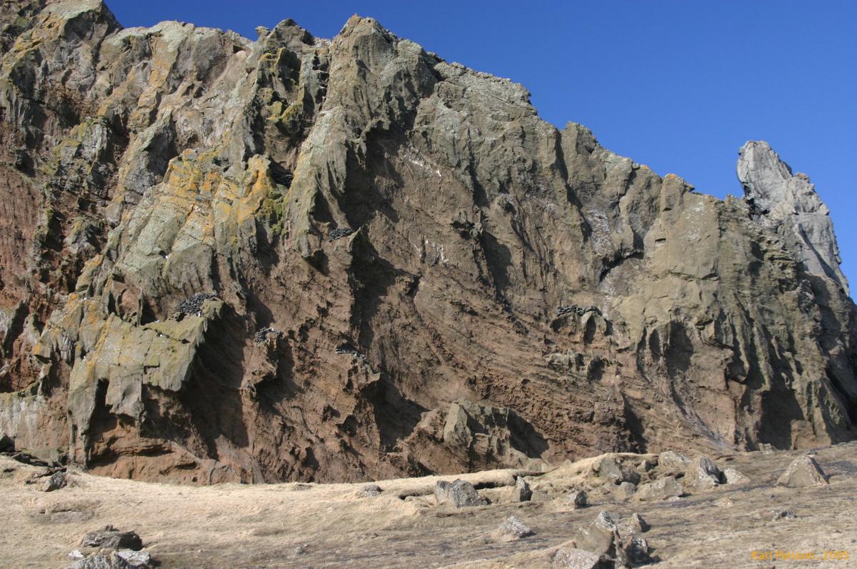 Odd grey rocks piled up on outofreach ledges