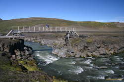 Neat bridge.  It's only anchored by stones piled on the ends