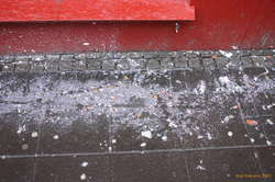 Filthy garbage after cleaners waterblasted some posters.