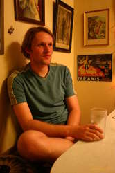 Karl drinking beer in his kitchen