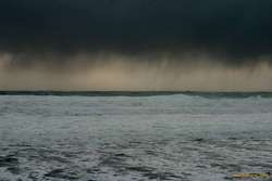 Virga over heavy seas near Grindavík