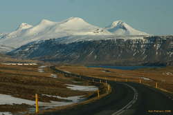 Winding down an empty road towards the head of Hvalfjörður, Botnsúla and Syðstasúla overhead