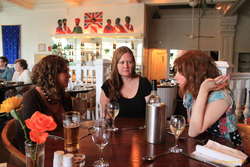 Bel, Eva and Tóta deep in conversation at The Raj, Leith